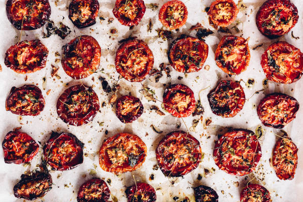 istock Prepared Sun Dried Tomatoes with Herbs on Parchment Paper 1403303205