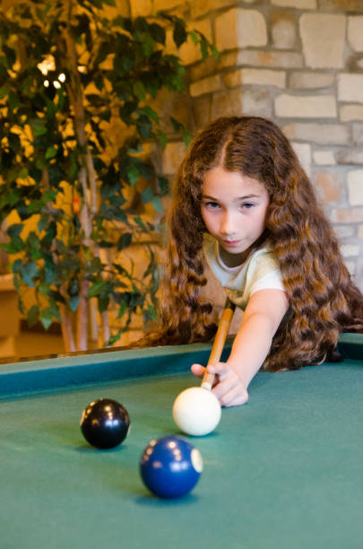 istock Teenage girl playing pool 1403304791
