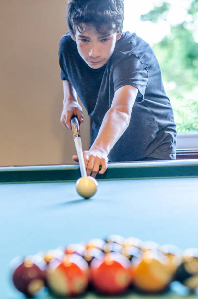 istock Teenage boy playing pool 1403305027
