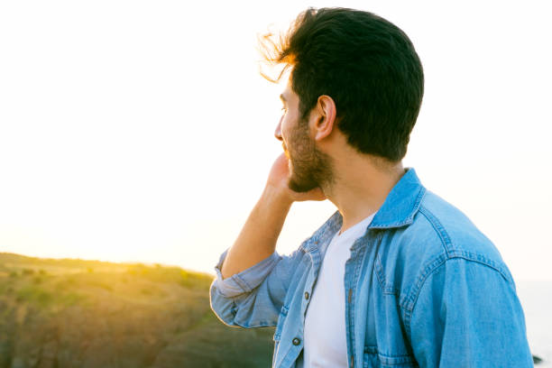 istock Happy handsome man using mobile phone at sunset on outdoor 1403305144