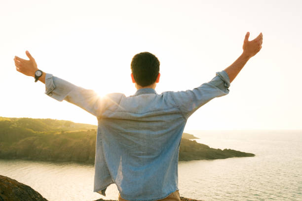 istock Arms raised happy success winning man looking away 1403306319