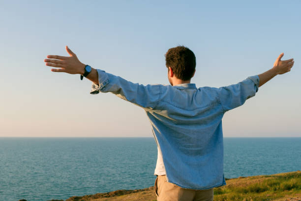 istock Arms raised happy success winning man looking away 1403306353