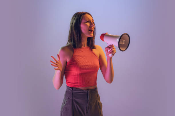 istock Excited young beautiful girl shouting at megaphone isolated on gradient blue pink neon background. Concept of emotions, facial expression, ad 1403306980