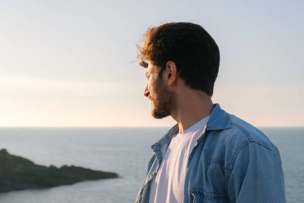 Man looking away portrait at sunset