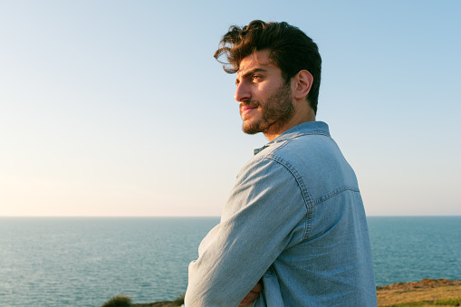 Man looking away portrait at sunset