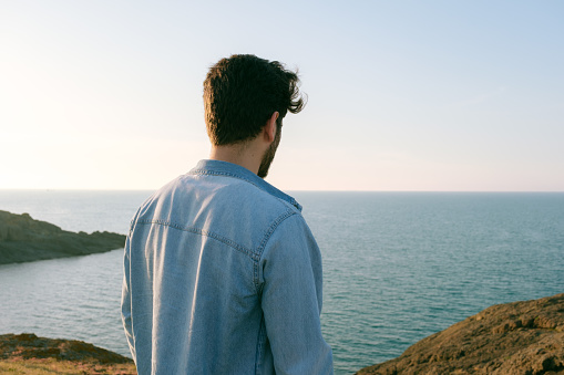 Man looking away portrait at sunset