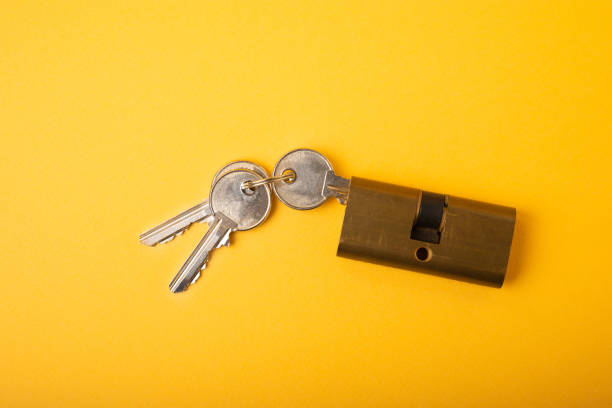 istock New door lock on a yellow background. 1403308187
