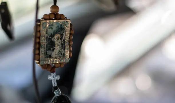 Photo of Wooden icon amulet in the car of Nicholas the Wonderworker on a string double sided. The icon is conveniently hung on the rearview mirror. Translation: Seraphim of Sarov the Wonderworker.