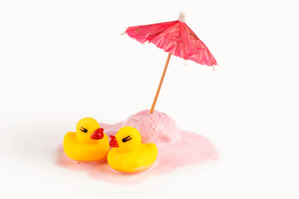 Inflatable mini yellow chicken or duckling on white background, pool float party. Flat lay copy space. Trend Inflatable Children toy for swimming. Creative summer beach concept. Layout for design.