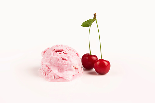 Scoop ice cream with cherry isolated on white