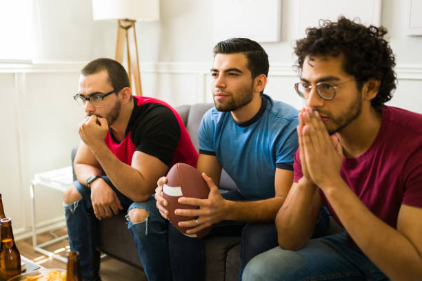 istock Attractive men feeling anxious while watching their favorite football team 1403313500