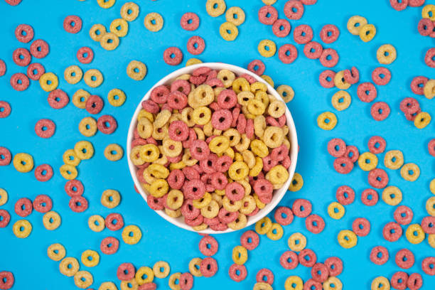 istock Corn rings of quick breakfast powder on a plate on a blue background, top view 1403313672