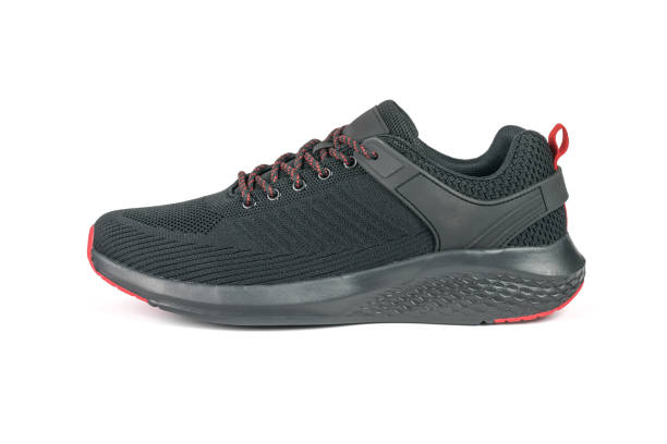 istock Side view of a black sneaker with red laces isolated on a white background. 1403317522