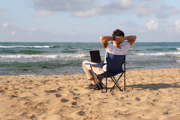 istock Young man working from away at coastline 1403318803