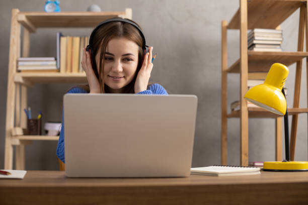 istock Girl writing in notebook noting thinking idea solitions. Student woman online larning 1403318947