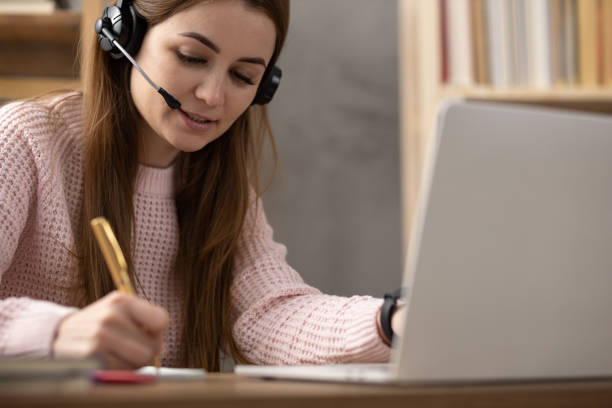istock Girl writing in notebook noting thinking idea solitions. Student woman online larning 1403318974