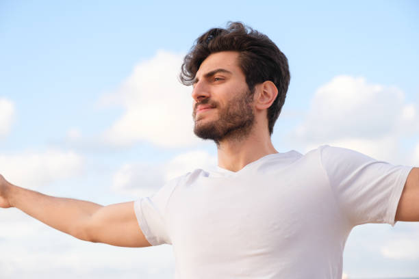 istock Arms raised happy success winning man looking away 1403320254