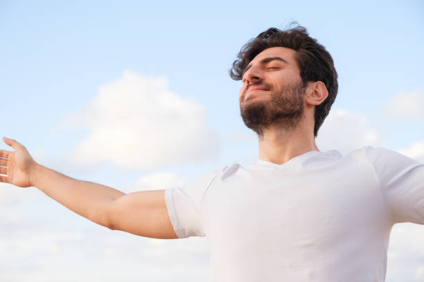 istock Arms raised happy success winning man looking away 1403320258