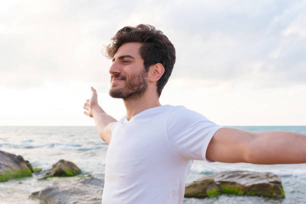 istock Arms raised happy success winning man looking away 1403320281