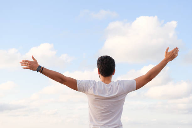 istock Arms raised happy success winning man looking away 1403320285