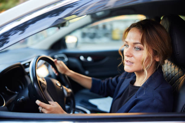 istock A businesswoman is driving a car to work. 1403321527