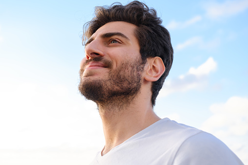 Man looking away portrait at sunset