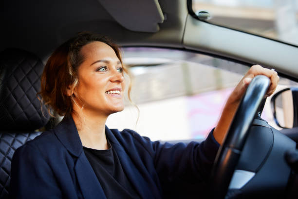 istock A businesswoman is driving a car to work. 1403321546