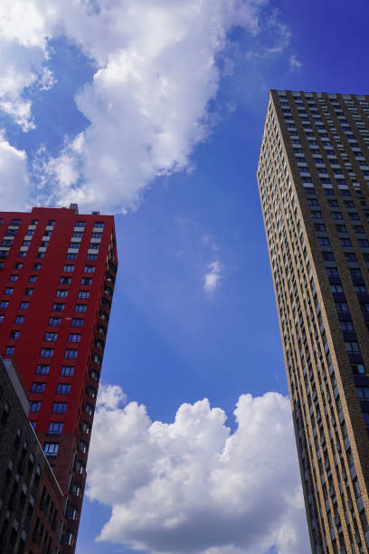 nowoczesne wieżowce budynków mieszkalnych na tle błękitnego nieba z chmurami, widok pod niskim kątem - investment real estate construction residential structure zdjęcia i obrazy z banku zdjęć