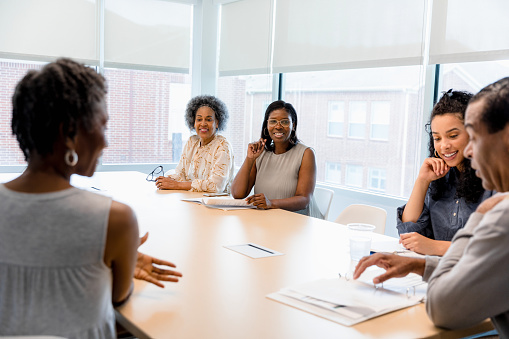 Mid adult businesswoman talking on a presentation in the meeting room