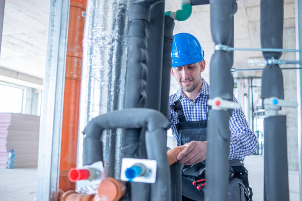 istock A cheerful plumber works at a construction site. 1403324957