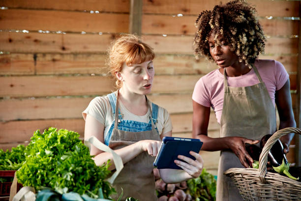 istock Female farm workers checking details on digital tablet 1403325050