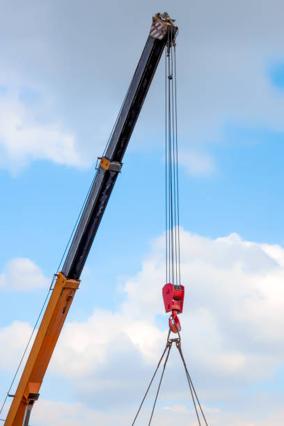istock A crane boom raised high against the sky 1403326486