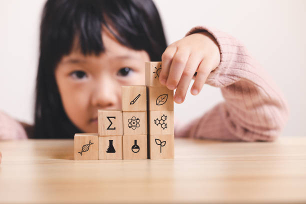 istock Asian kid stack small wooden block to stair. Concept for kid learning and child development. 1403338384
