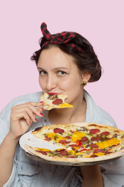 istock woman with pizza 1403339140
