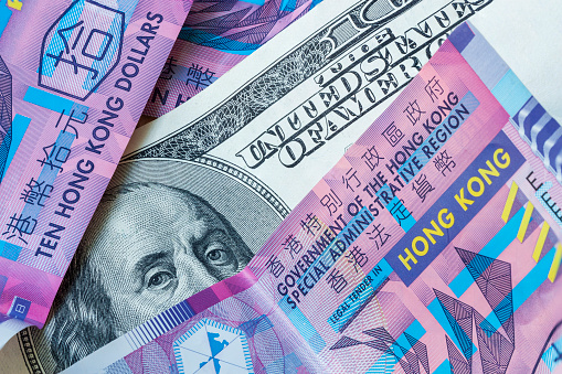 US Dollar and Hong Kong Dollar Money Banknotes close-up, abstract background