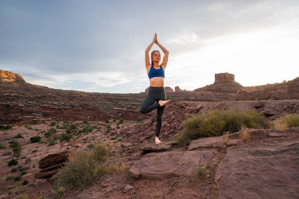istock .Beautiful Young Woman Striking A Tree Pose While Practicing Yoga In The Desert Near Moab, Utah 1403341103