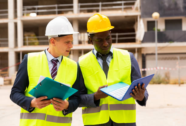 istock Two civil engineers controls the progress of work on a laptop 1403341378