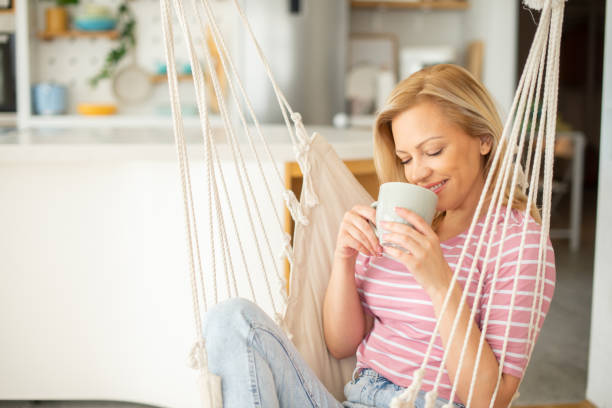 istock Beautiful woman relaxing and drinking hot tea 1403345295
