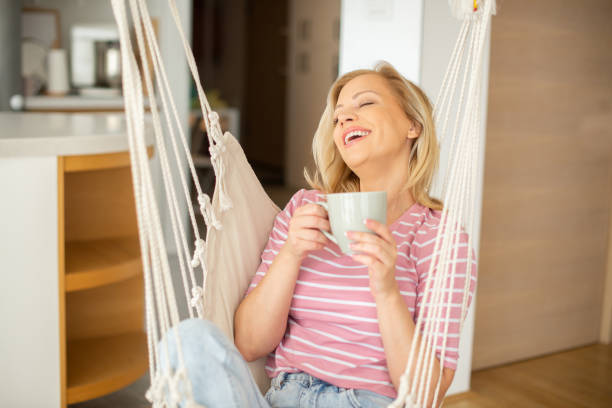 istock Woman having coffee and relaxing at home 1403345313