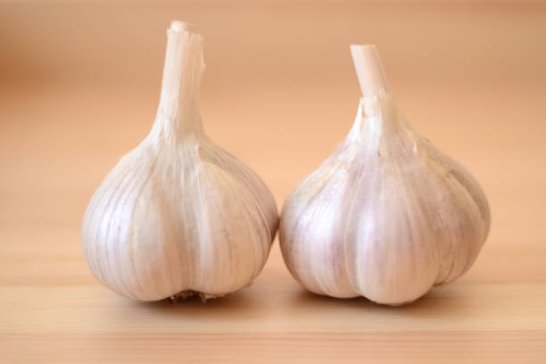 Garlic bulbs with a wooden background stock photo