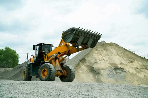 istock Sand loaders are shoveling rocks into dump trucks. 1403350125