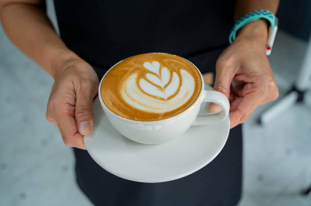 istock hot latte art coffee on hand table, relax time 1403350212