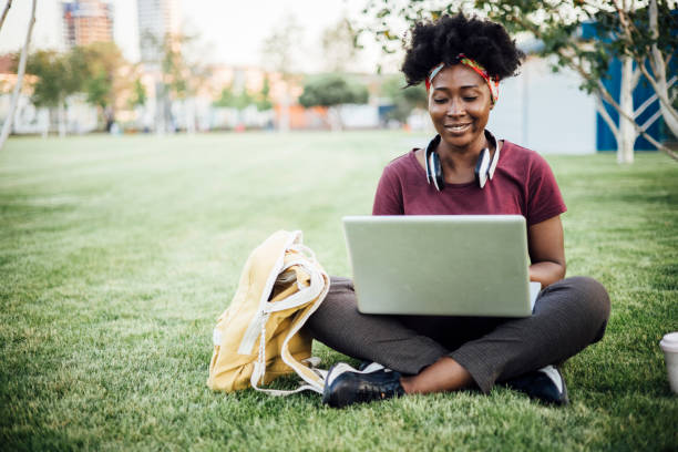 istock African American student enjoying in the park and studying 1403351316