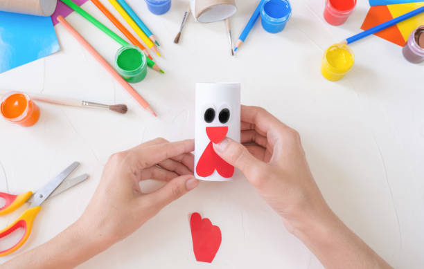 istock step3. The concept of decorating a kindergarten with easter - a chicken, a rooster from a roll of toilet paper. A simple creative idea with your own hands. Eco friendly recycled decor kids paper crafts 1403351529
