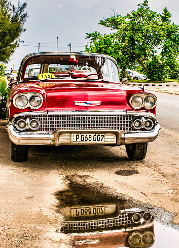Havana, Cuba - July 06 2018 : Old vintage american cars are abundant on Cuba because of the embargo. most are taxis for tourists.