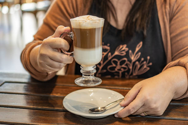 istock a woman drinking a cappuccino in a bar. 1403354392