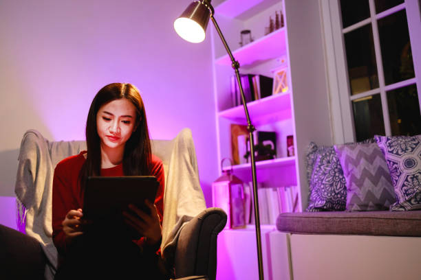 istock Asain Beautiful woman using a digital tablet at home at the night time 1403355181