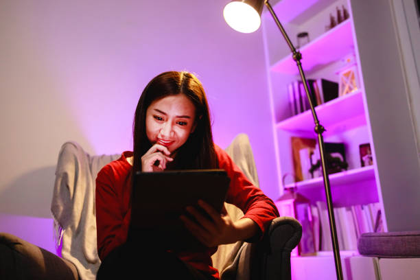 istock Woman relaxing on armchair with digital tablet 1403355192