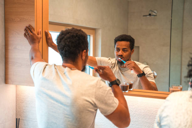 istock Handsome Mixed Race Male Brushing His Teeth In The Morning 1403359947