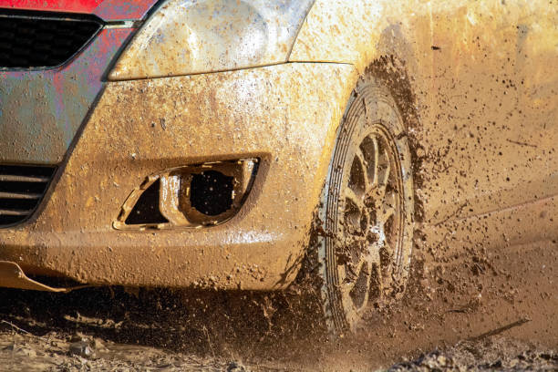 istock Car stuck in mud during construction of main road 1403360565
